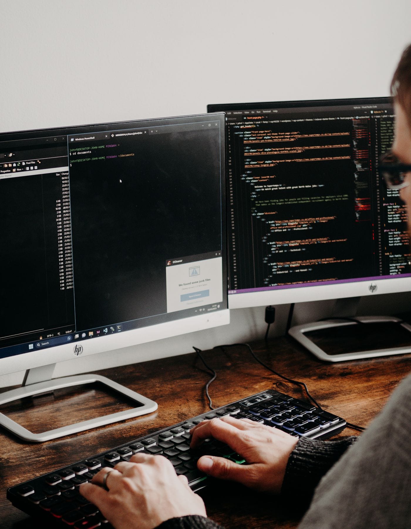 Specialist working at a dual-monitor engineering workstation