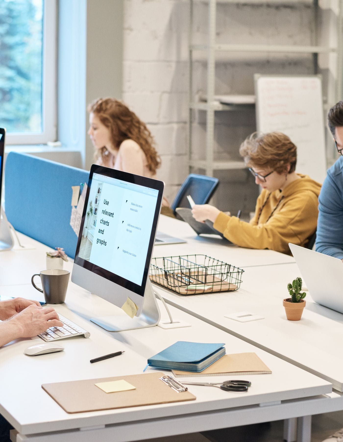 Engineers at work on computers in an open-plan office