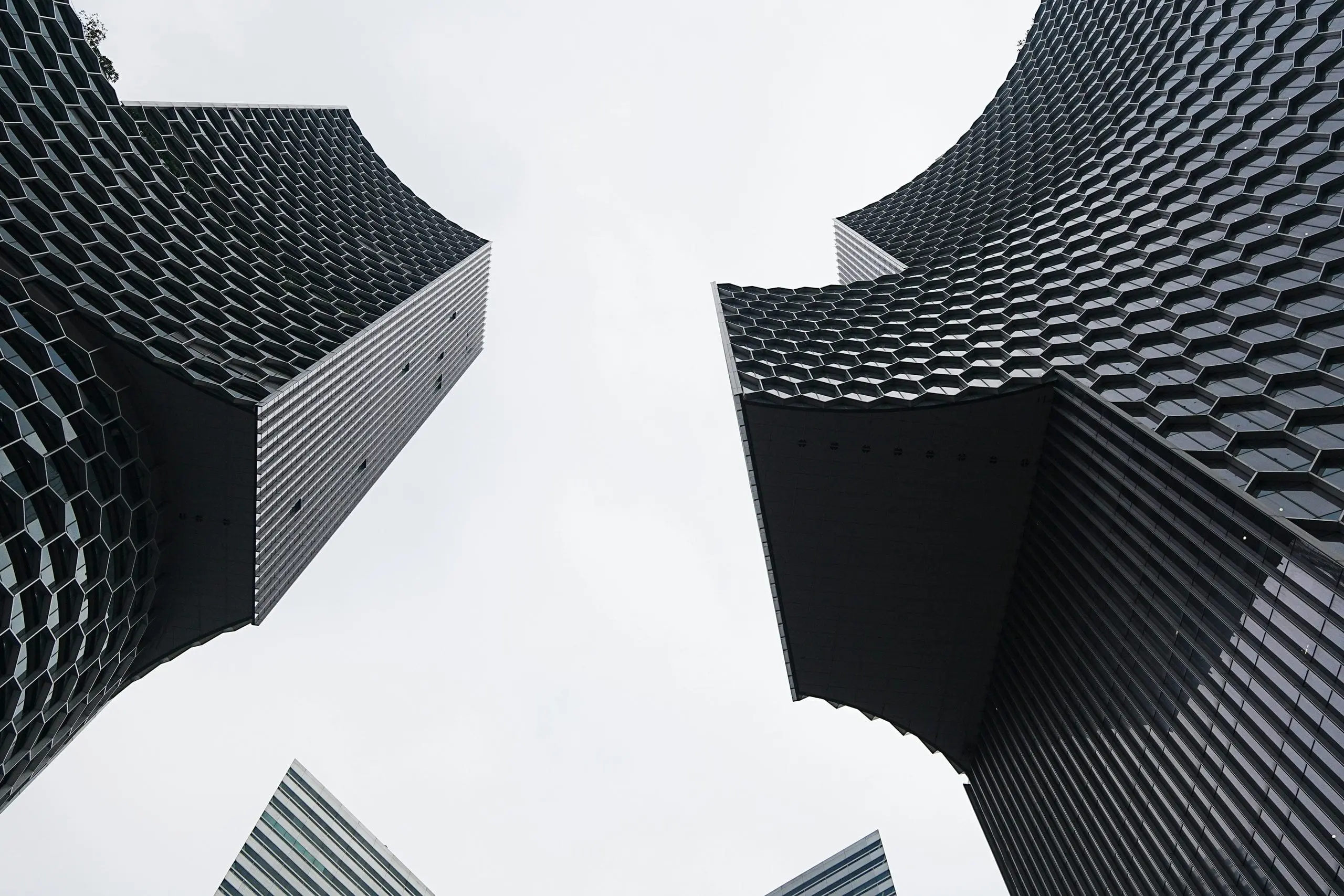 Upward view of the sky between two tall buildings