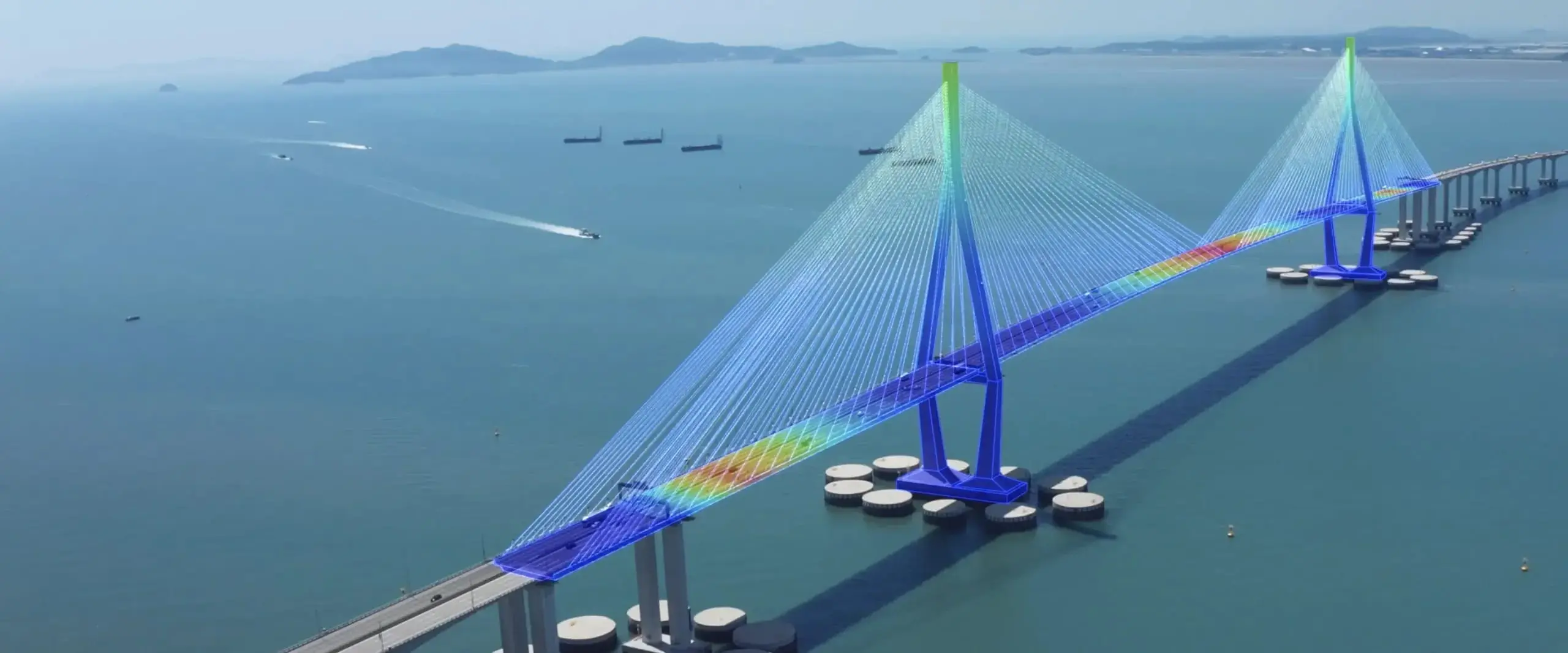 Cable-stayed bridge over the sea overlaid with a colour stress analysis